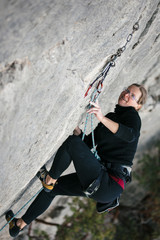 woman climbs a rock