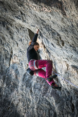 woman climbs a rock