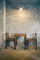 Wooden table and chair in the restaurant with pendant light
