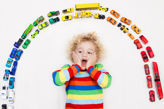 Little boy playing with toy cars. Toys for kids.