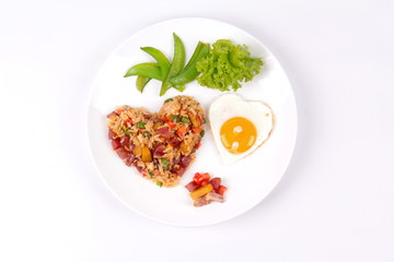 Chinese sausage fried rice and sunny egg in heart shapes.