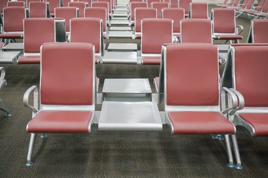 row of red seats at airport terminal