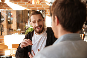 View from back of man with his friend near bar