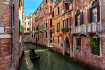 Fototapeta na wymiar Gondola among old houses in Venice.