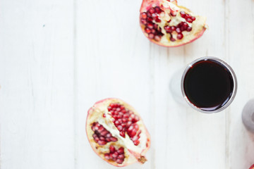 Top view of pomegranate juice on white wooden table.