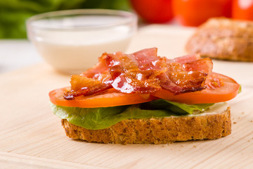 bacon sandwich on wooden table