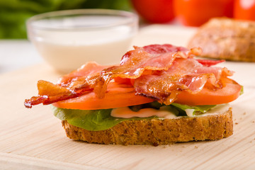 bacon sandwich on wooden table