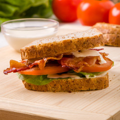 bacon sandwich on wooden table