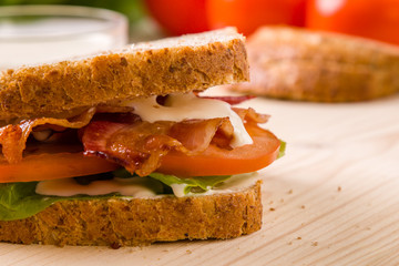 bacon sandwich on wooden table