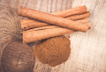 Cinnamon sticks on wooden background.