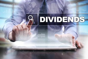 Businessman using tablet pc and selecting dividends.