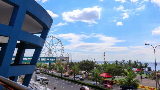 Timelapse view over Manila bay with ferry wheel at Mall of Asia, Manila, Philippines