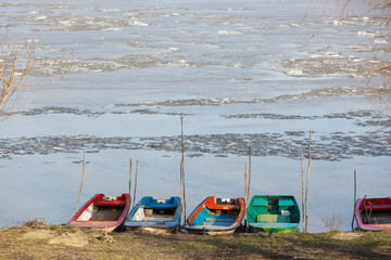 Fishing boats tied to the shore during winter time