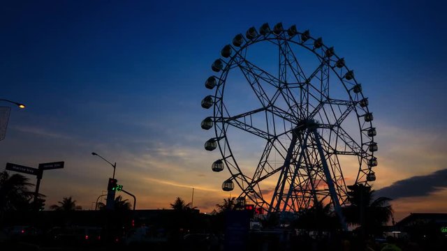 Sunset silhouette of Ferris wheel