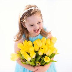 Little girl with tulip flower bouquet