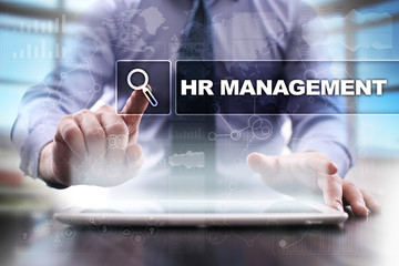 Businessman using tablet pc and selecting hr management.