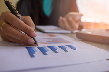 Businesswomen working new start up project. Finance task.Digital tablet docking keyboard laptop computer smart phone in morning light. Concept business and finance 