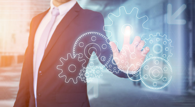 Businessman touching technology interface with gear wheel settin