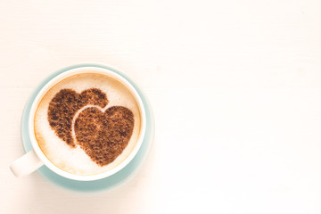 Coffee with decorated heart shaped cinnamon powder. St. Valentine's Day. Love. White background with copy space for text