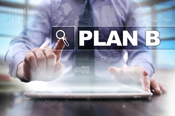 Businessman using tablet pc and selecting plan b.