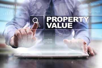 Businessman using tablet pc and selecting property value.