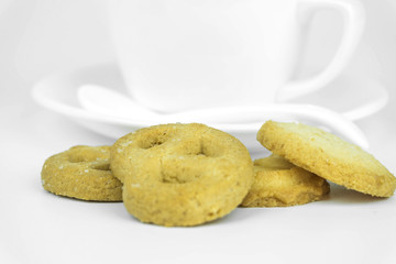 Coffee cup and candy on white background.