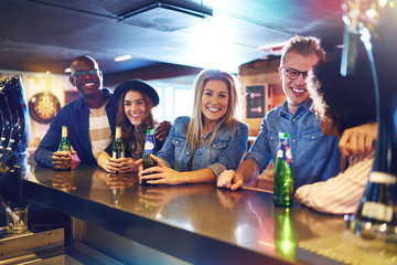 Happy group of people drinking in bar