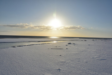 朝日と雪の砂浜