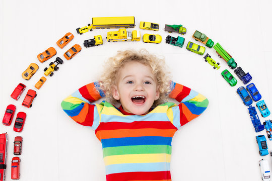 Little boy playing with toy cars. Toys for kids.