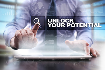 Fototapeta na wymiar Businessman using tablet pc and selecting unlock your potential.