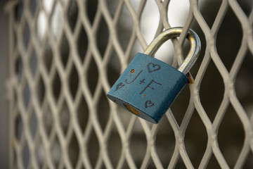 Detail of padlock locked on mesh