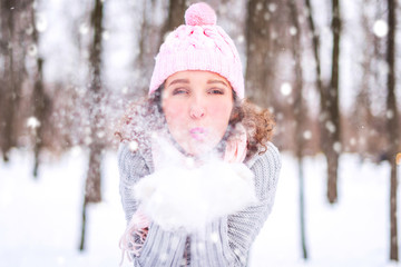 Winter young woman portrait. Beauty Joyful Model Girl having fun in winter park. Beautiful young woman laughing outdoors. Enjoying nature, wintertime