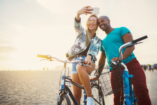 couple taking a break from riding bikes to take selfies