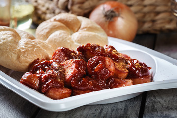 Delicious German currywurst - pieces of sausage with curry sauce