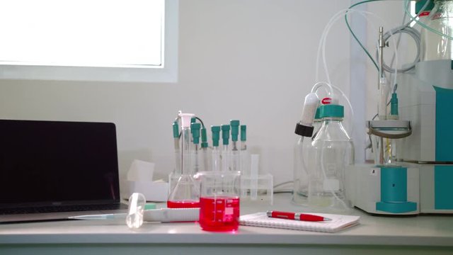 Science lab equipment panning on. Automatic titrator in biotechnology lab. Laboratory glassware. Modern laboratory equipment. Chemical laboratory equipment. Science laboratory. Research lab