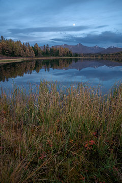 Mirror Surface Lake Autumn Vertically Orientated Landscape With Mountain Range On Background
