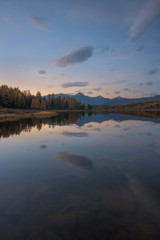 Mirror Surface Lake Vertical Orientation Autumn Landscape With Mountain Range In Early Eveing With Stars On The Sky