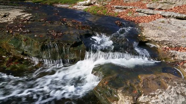 Water splashes over Clinton Falls, a small beautiful waterfall in rural western Indiana.