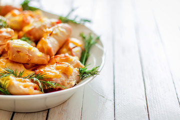 Roast chicken with fennel on a white wooden background