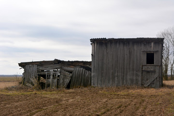 Fototapeta na wymiar Two old wooden barn, a barn for hay storage, vintage