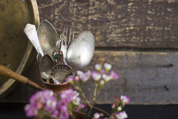A set of antique cutlery on a wooden background
