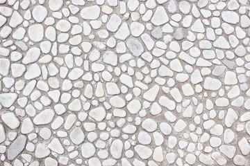 Wall of small stones, white background  light design