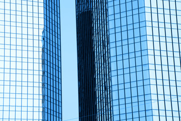 Two tall glass buildings in monochrome