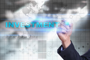 Businessman is drawing on virtual screen. investment concept.