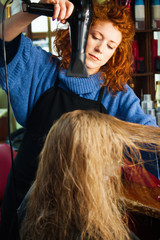 young woman in her hair studio with customer