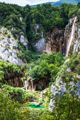 Fototapeta na wymiar Cascades waterfalls falling from the rocks in the woods. Plitvic