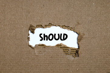 The word should appearing behind torn paper