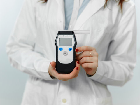 Breathalyzer in the hands of the physician closeup