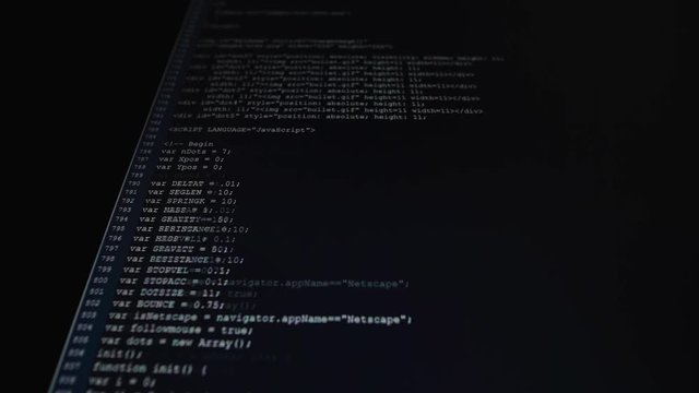 The process of writing a computer program on a computer monitor. Text is entered and quickly moved up. A large number of rows of symbols. Work on the software.