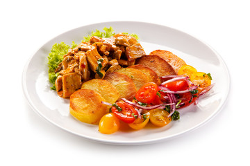 Goulash with baked potatoes and vegetables 